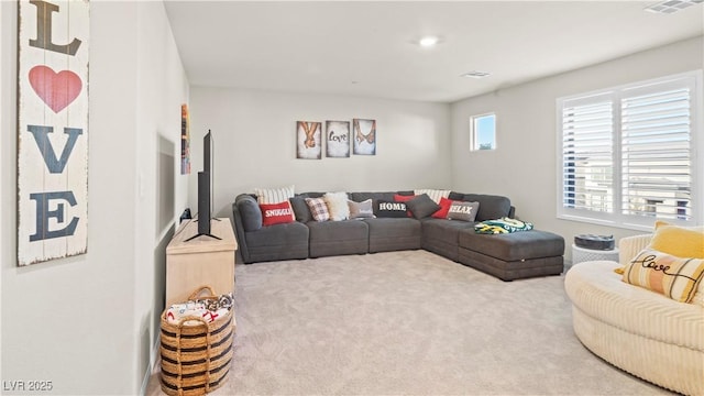 living area with carpet and visible vents