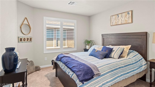 bedroom with visible vents, light carpet, and baseboards