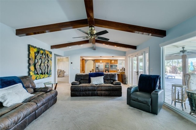 living room with vaulted ceiling with beams, ceiling fan, and light colored carpet