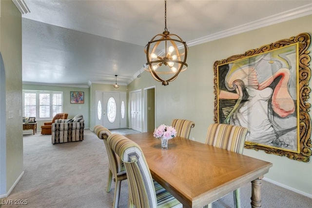 carpeted dining room featuring lofted ceiling, baseboards, ornamental molding, and a chandelier