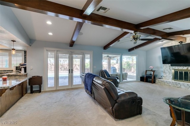 living room with light carpet, french doors, lofted ceiling with beams, and visible vents