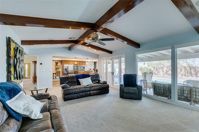 living area with light carpet, a ceiling fan, visible vents, and vaulted ceiling with beams