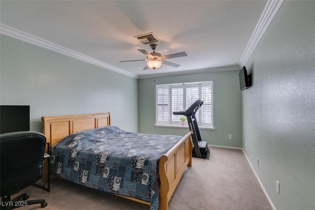 carpeted bedroom featuring visible vents, baseboards, ceiling fan, and crown molding