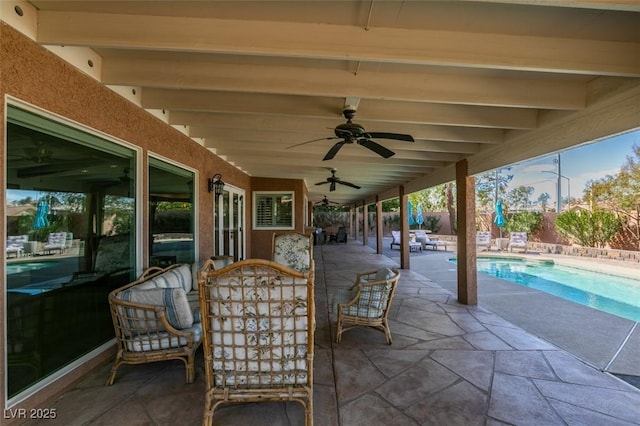 view of patio featuring ceiling fan, fence private yard, and a fenced in pool