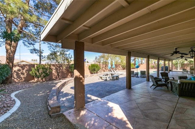 view of patio / terrace with outdoor dining area, a fenced backyard, and a ceiling fan