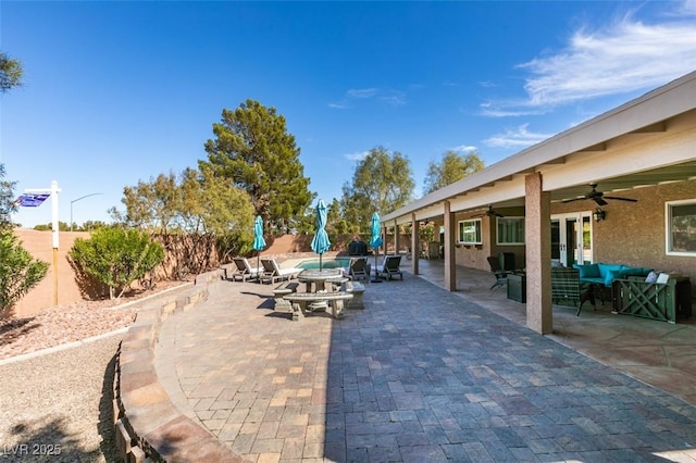 view of patio featuring ceiling fan, a fenced backyard, and french doors