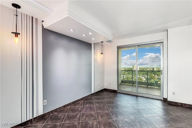 spare room featuring dark tile patterned flooring, recessed lighting, and baseboards