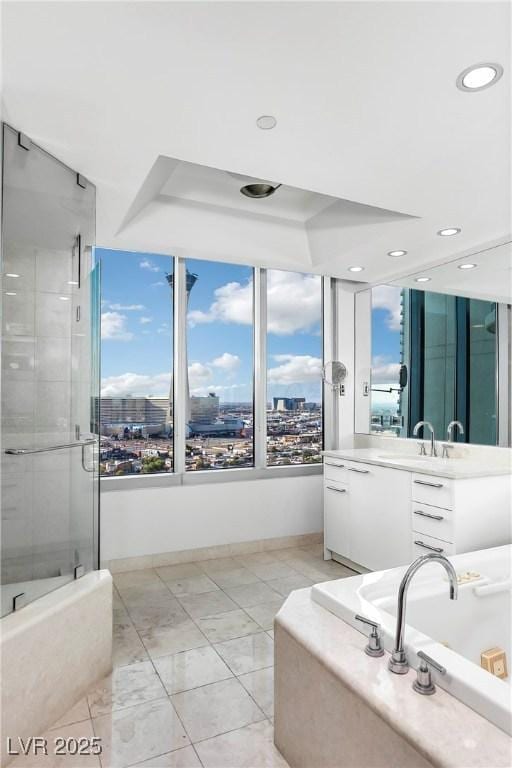 full bathroom with recessed lighting, a city view, vanity, a bath, and a stall shower