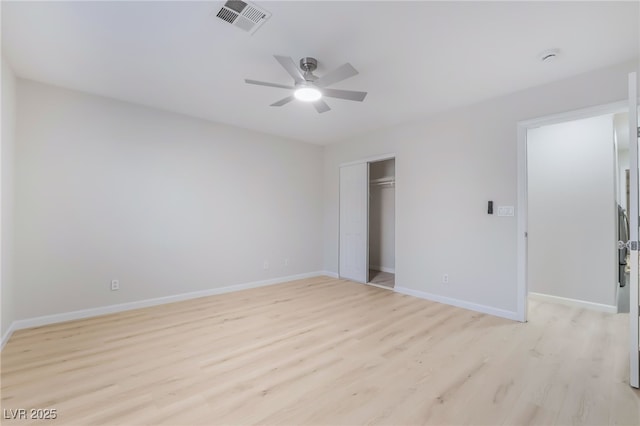 unfurnished bedroom featuring a closet, visible vents, light wood-style floors, a ceiling fan, and baseboards