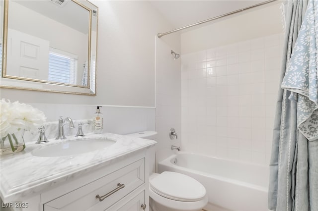 bathroom with visible vents, bathing tub / shower combination, vanity, and toilet