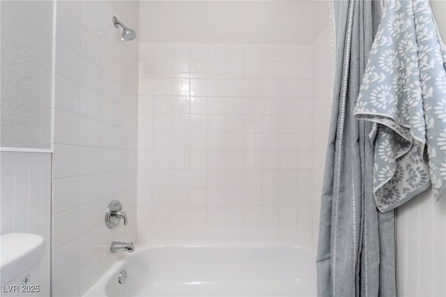 full bathroom with toilet, shower / tub combo, and wainscoting