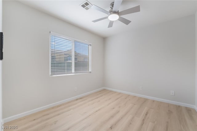 spare room featuring visible vents, ceiling fan, light wood finished floors, and baseboards