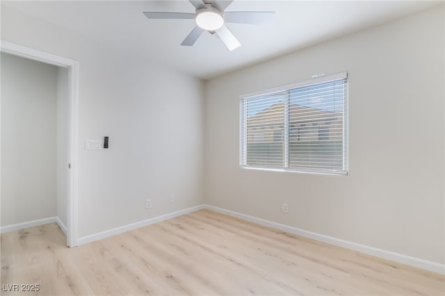 unfurnished room featuring light wood finished floors, a ceiling fan, and baseboards