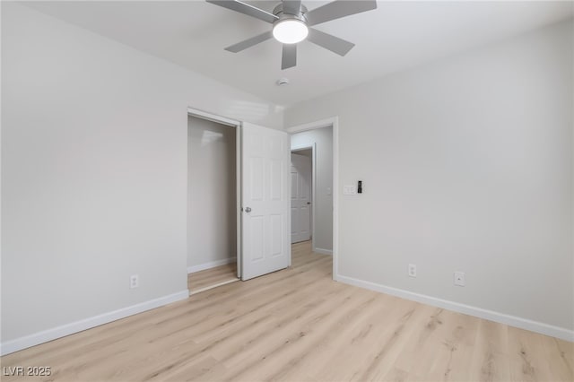 unfurnished bedroom with a ceiling fan, baseboards, and light wood finished floors