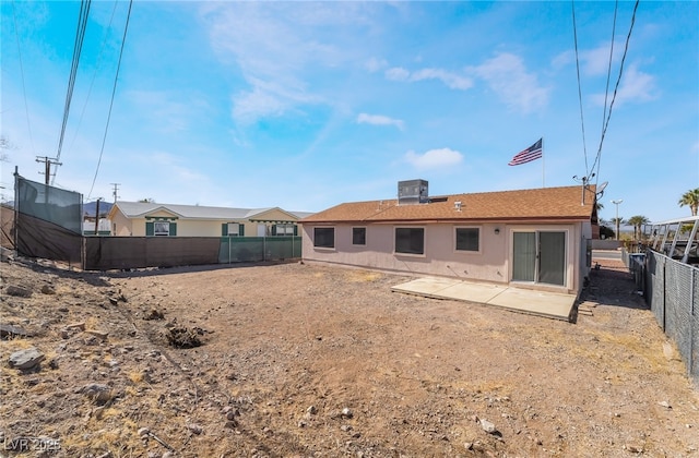 rear view of property featuring a fenced backyard, a patio, and central air condition unit