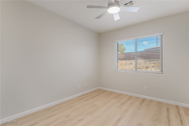 unfurnished room featuring ceiling fan, visible vents, light wood-style flooring, and baseboards