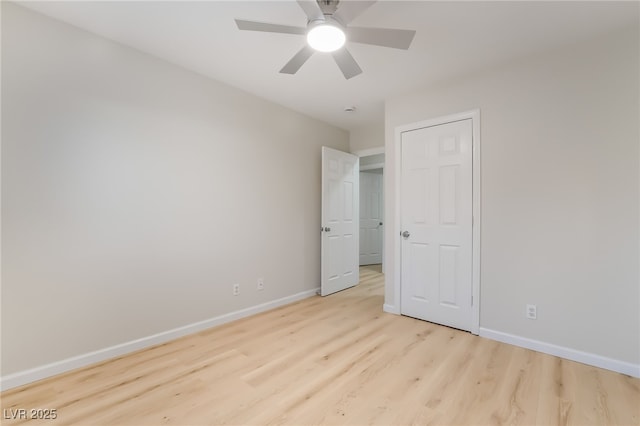 unfurnished bedroom featuring light wood-style floors, ceiling fan, and baseboards