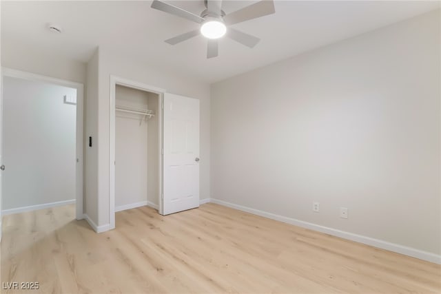 unfurnished bedroom featuring a closet, ceiling fan, light wood-style flooring, and baseboards