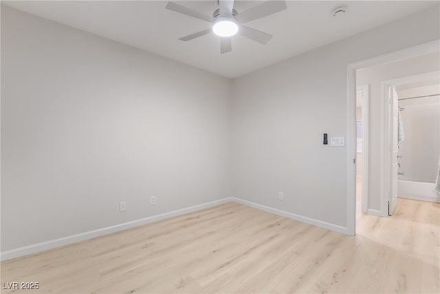 unfurnished room with light wood finished floors, baseboards, and a ceiling fan