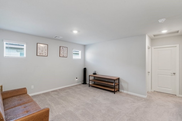 living area featuring light carpet, baseboards, and visible vents