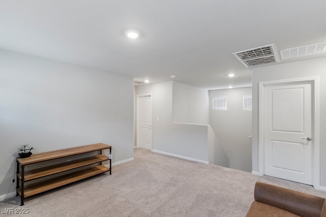 basement featuring recessed lighting, visible vents, baseboards, and light colored carpet