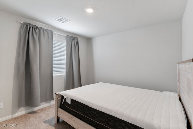 bedroom featuring baseboards, visible vents, and light colored carpet