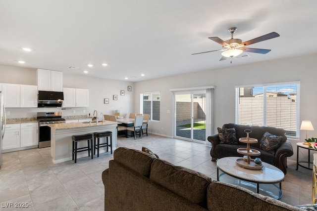 living room featuring recessed lighting, baseboards, visible vents, a ceiling fan, and light tile patterned flooring