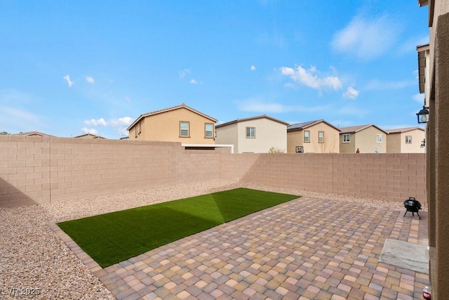 view of patio with a fenced backyard and a residential view