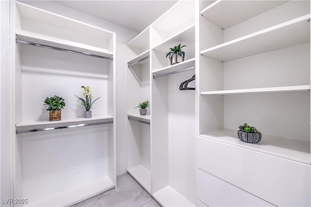 spacious closet with marble finish floor