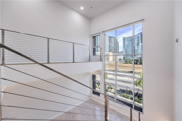 stairs featuring tile patterned floors, a city view, and recessed lighting