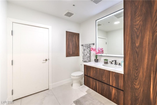 bathroom featuring baseboards, visible vents, vanity, and toilet