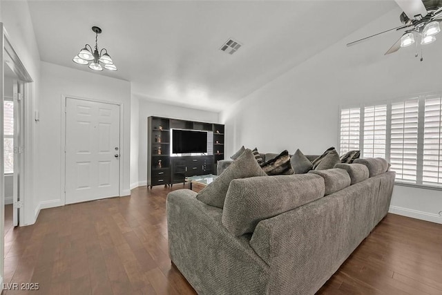 living room featuring a wealth of natural light, dark wood-style flooring, and visible vents