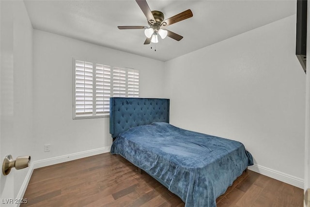 bedroom with a ceiling fan, dark wood finished floors, and baseboards