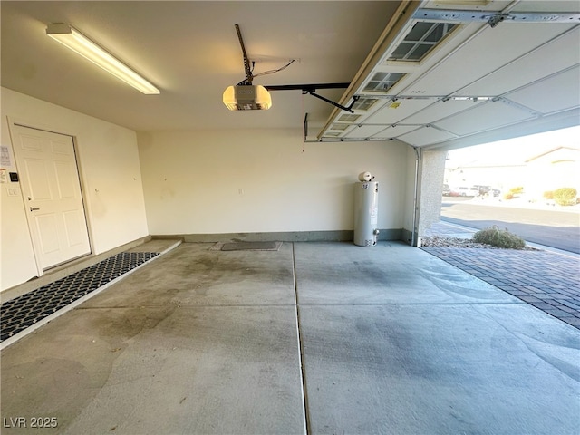 garage with a garage door opener and water heater