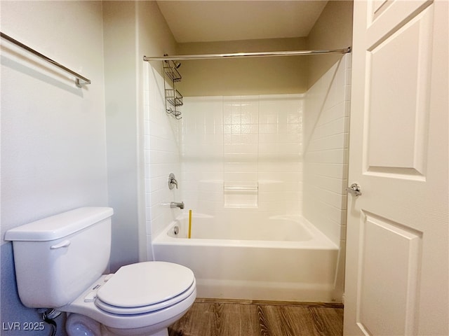 bathroom featuring shower / tub combination, wood finished floors, and toilet