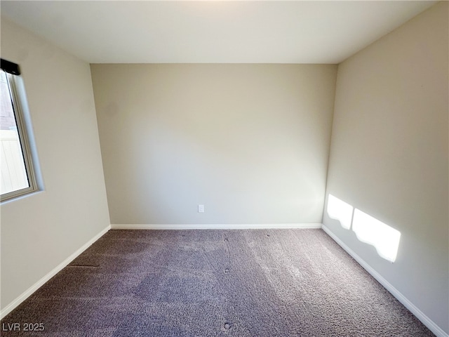 carpeted empty room with baseboards