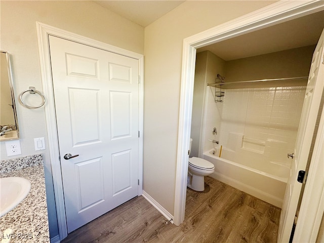 full bathroom with toilet, vanity, wood finished floors, and shower / bathtub combination