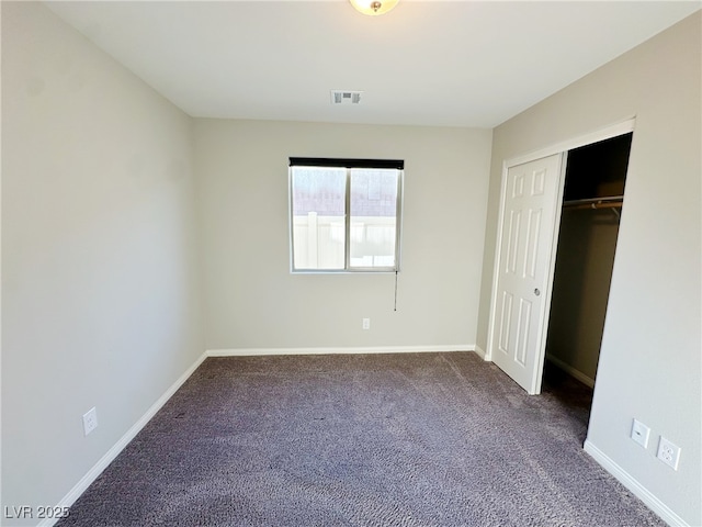 unfurnished bedroom featuring carpet flooring, visible vents, and baseboards