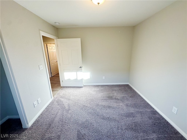 unfurnished bedroom featuring carpet floors and baseboards