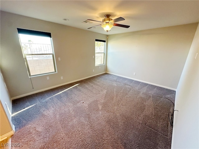 unfurnished room featuring carpet, visible vents, ceiling fan, and baseboards