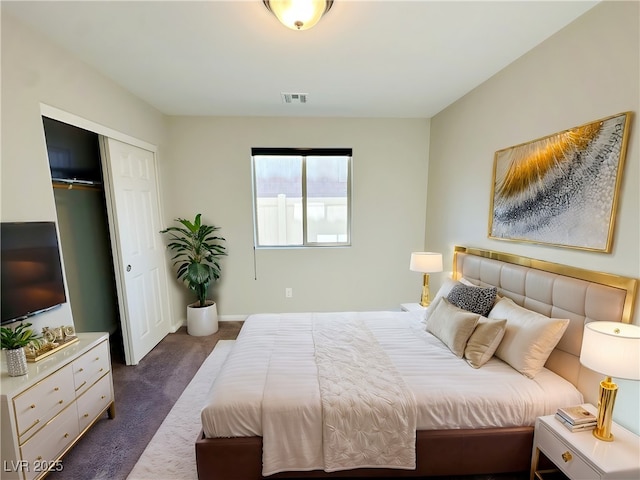 bedroom with a closet, visible vents, and dark carpet