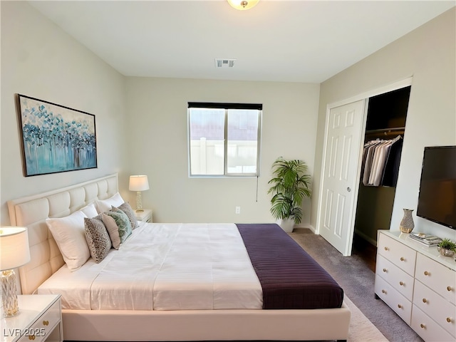 carpeted bedroom featuring a closet and visible vents