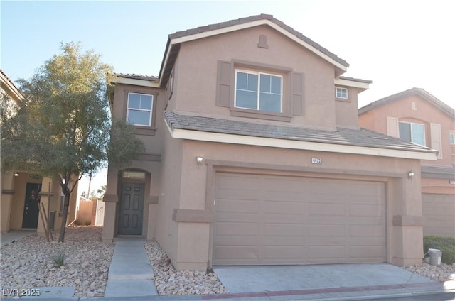 traditional-style home with a garage, a tiled roof, concrete driveway, and stucco siding