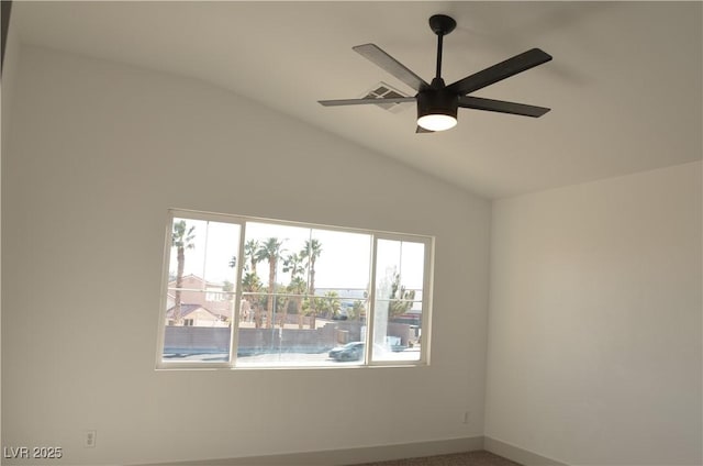 empty room with lofted ceiling, ceiling fan, and baseboards