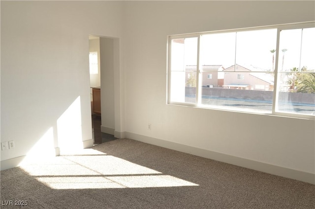 empty room with carpet flooring and baseboards