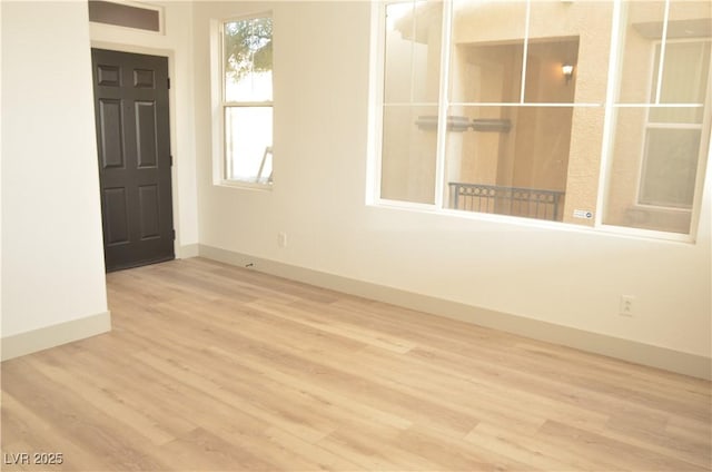 empty room with wood finished floors and baseboards