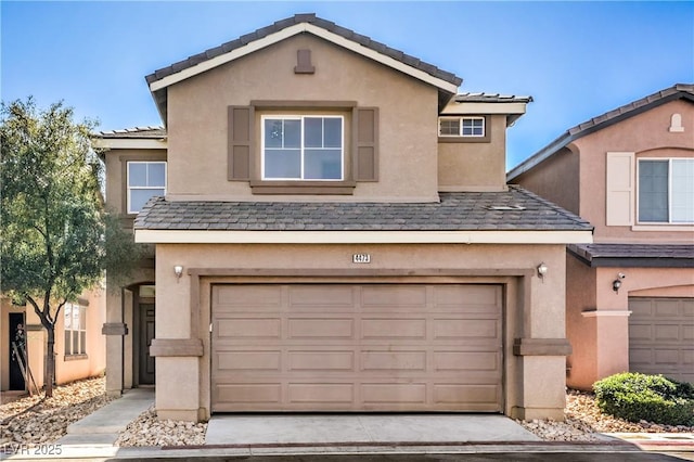 view of front of property with an attached garage and stucco siding