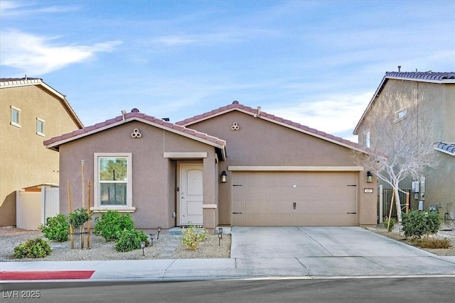 view of front of property with a garage, a tile roof, driveway, and stucco siding