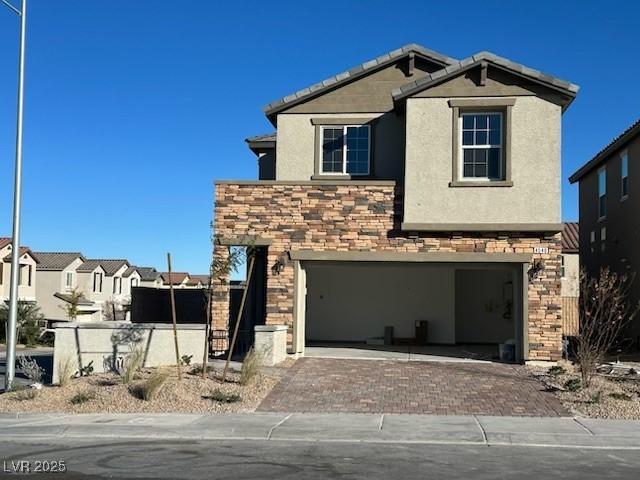 traditional-style home with a garage, stone siding, a residential view, decorative driveway, and stucco siding