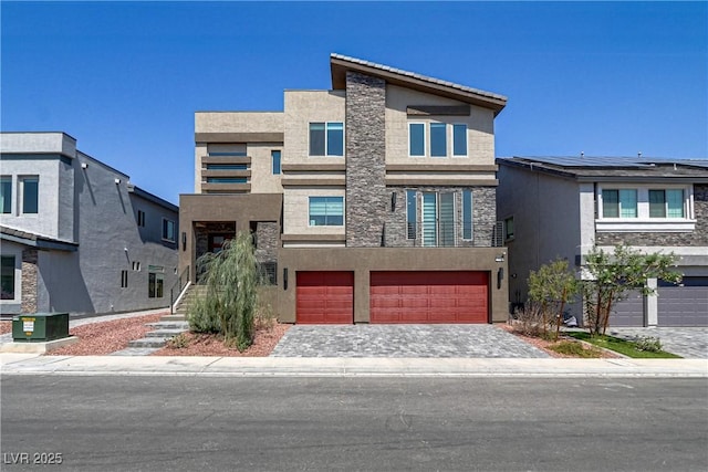 view of front of home featuring stone siding, an attached garage, decorative driveway, central air condition unit, and stucco siding